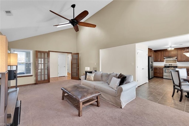 living room with visible vents, ceiling fan, carpet floors, french doors, and high vaulted ceiling