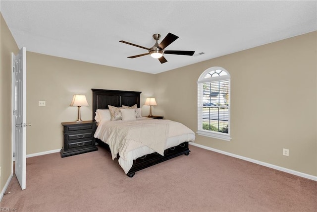 bedroom with carpet flooring, ceiling fan, visible vents, and baseboards