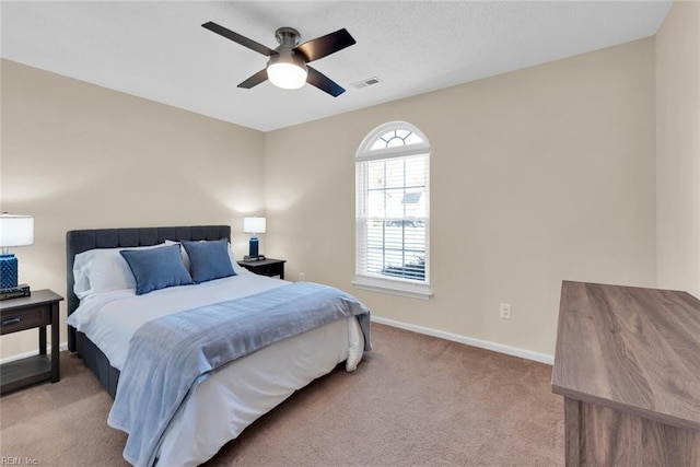 bedroom featuring visible vents, baseboards, carpet, and ceiling fan