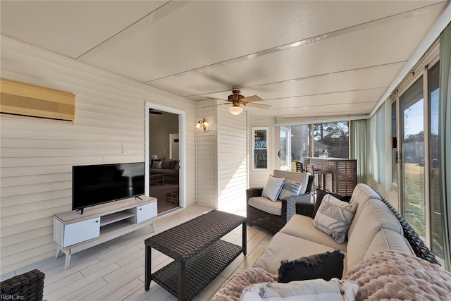 exterior space with a wall mounted AC, a ceiling fan, and wood finished floors