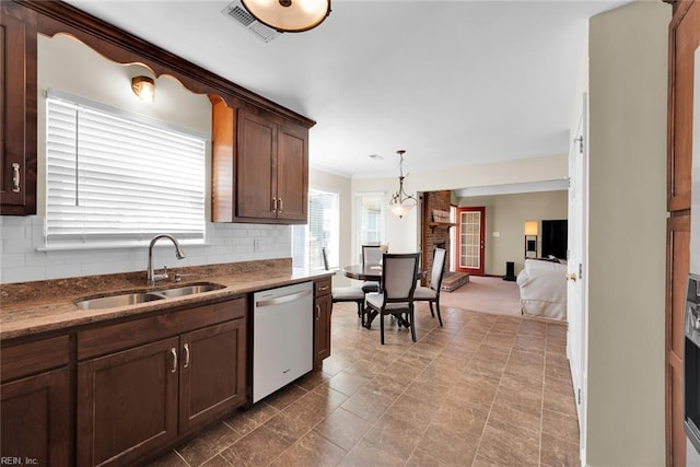 kitchen with visible vents, dishwasher, ornamental molding, decorative backsplash, and a sink