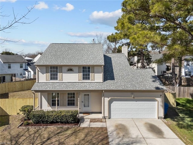 traditional home with an attached garage, fence, driveway, and roof with shingles