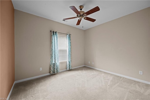 empty room featuring visible vents, a ceiling fan, baseboards, and carpet floors