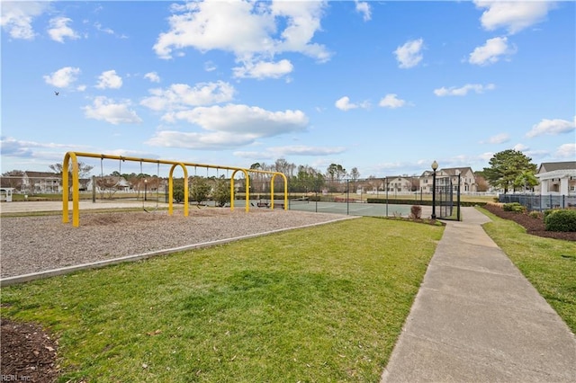 communal playground with a yard and fence