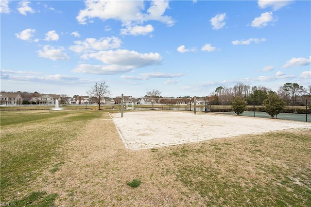 surrounding community featuring a residential view, a lawn, and volleyball court