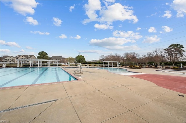 pool featuring a pergola and a patio area