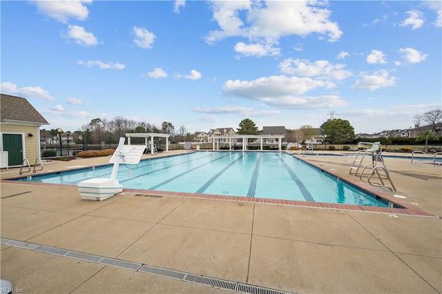 community pool with a patio, fence, and a pergola