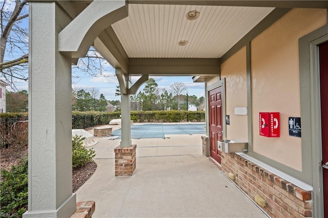 view of patio featuring a fenced in pool and fence