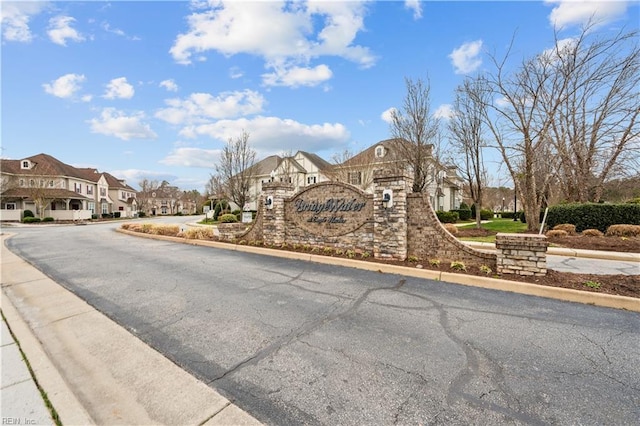 view of road with curbs and a residential view