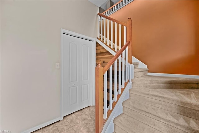 staircase featuring baseboards