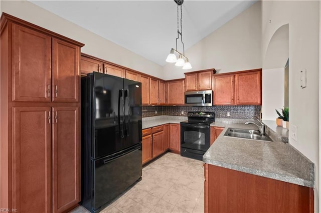 kitchen featuring hanging light fixtures, black appliances, brown cabinetry, and a sink