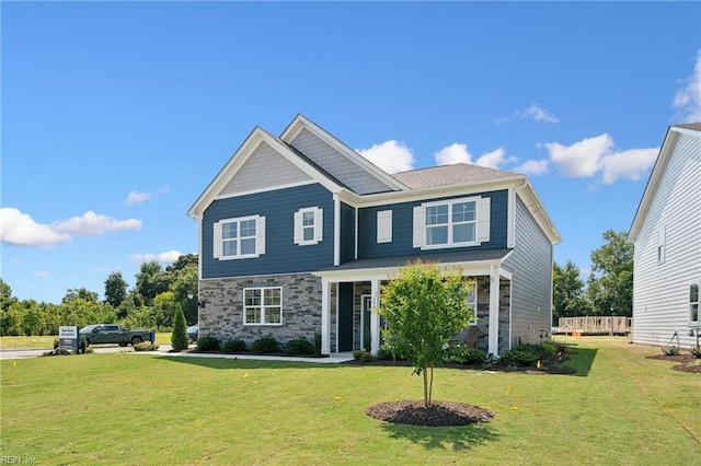 craftsman-style house with a front lawn and stone siding