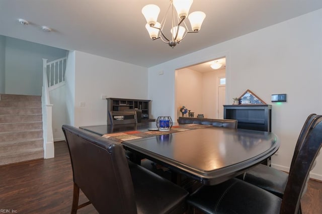 dining space featuring stairway, baseboards, dark wood-type flooring, and a chandelier