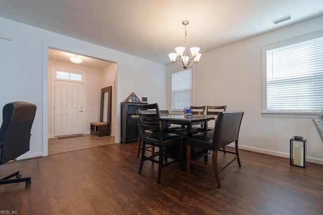 dining room with visible vents, baseboards, an inviting chandelier, and dark wood-style floors