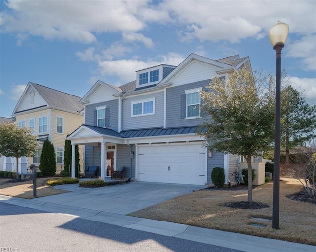 view of front of home featuring driveway, a standing seam roof, a porch, metal roof, and a garage