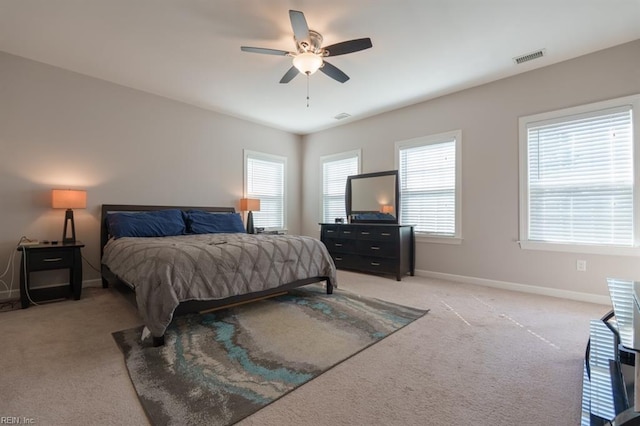 bedroom with visible vents, carpet floors, baseboards, and ceiling fan