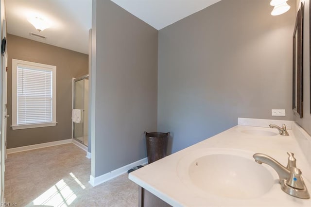 full bathroom featuring a sink, visible vents, baseboards, and a stall shower