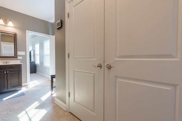 interior space with vanity and baseboards