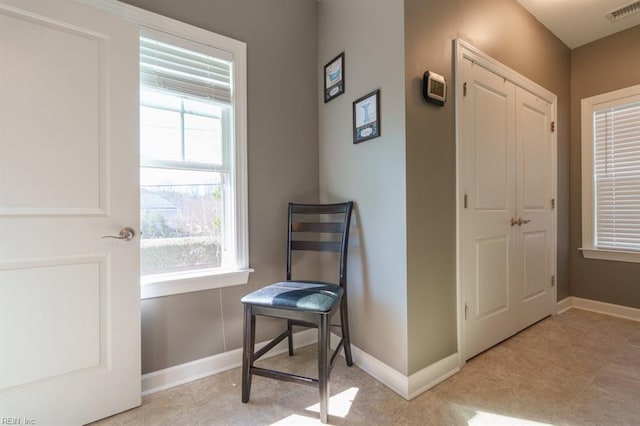 interior space featuring baseboards and visible vents