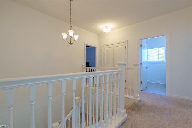 corridor featuring an upstairs landing, carpet flooring, and baseboards