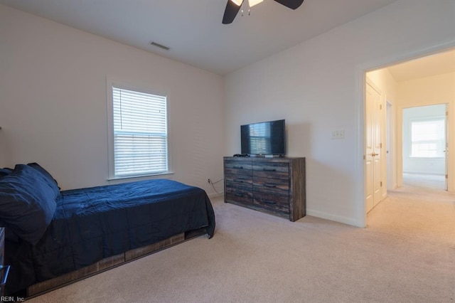 bedroom with visible vents, baseboards, carpet, and a ceiling fan