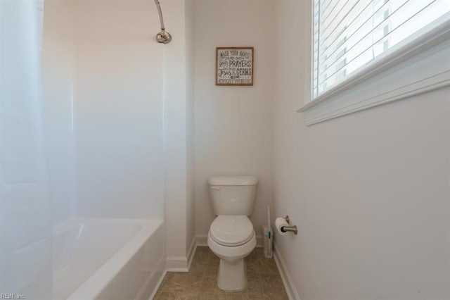 bathroom featuring tile patterned floors, toilet, and baseboards