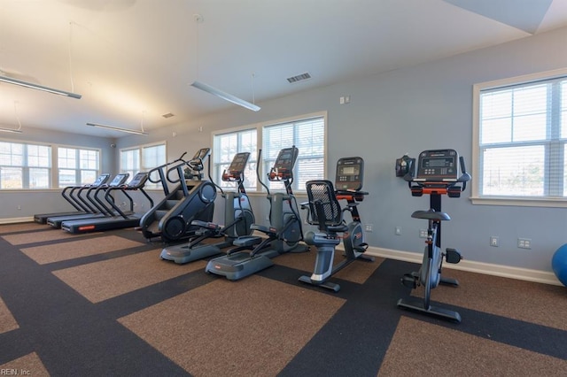 gym with a wealth of natural light, visible vents, and baseboards