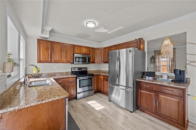 kitchen with ornamental molding, a sink, light stone counters, stainless steel appliances, and brown cabinetry