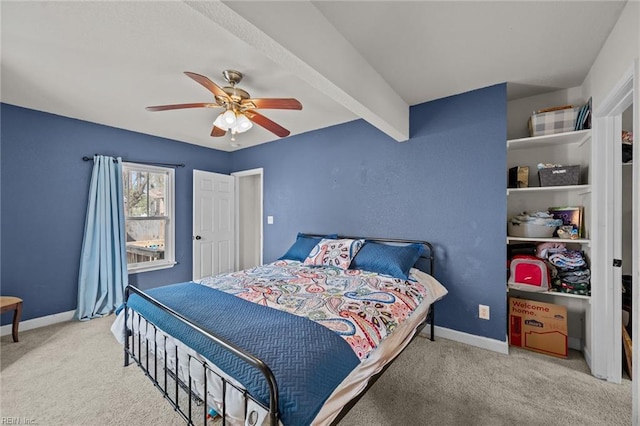 bedroom with beamed ceiling, ceiling fan, baseboards, and carpet floors