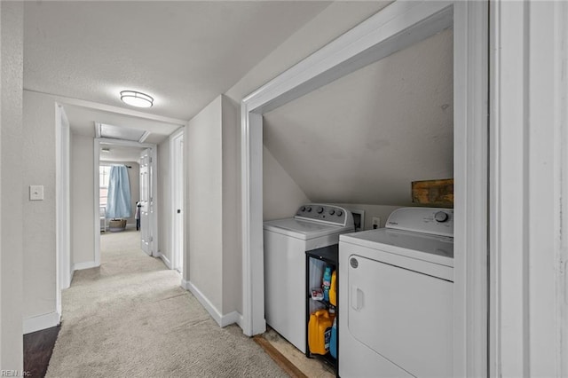 clothes washing area with laundry area, attic access, separate washer and dryer, a textured ceiling, and light carpet