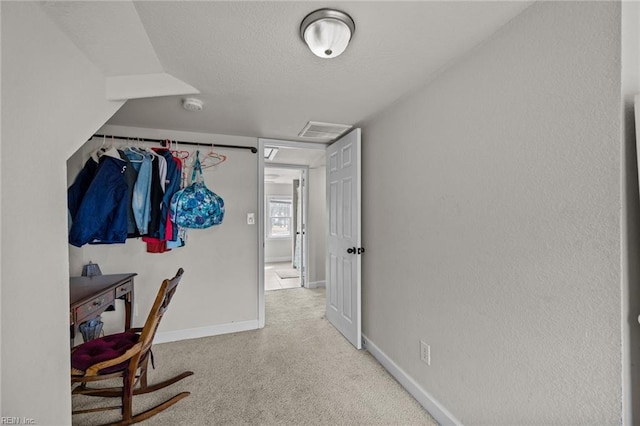 interior space with visible vents, baseboards, a textured ceiling, and carpet flooring