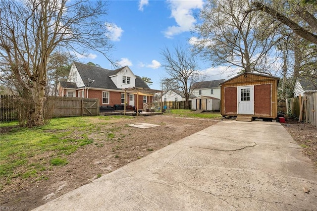 view of yard with an outbuilding, a fenced backyard, entry steps, and a shed