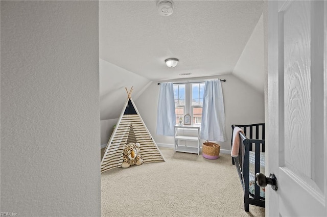 rec room with a textured wall, a textured ceiling, carpet, and vaulted ceiling