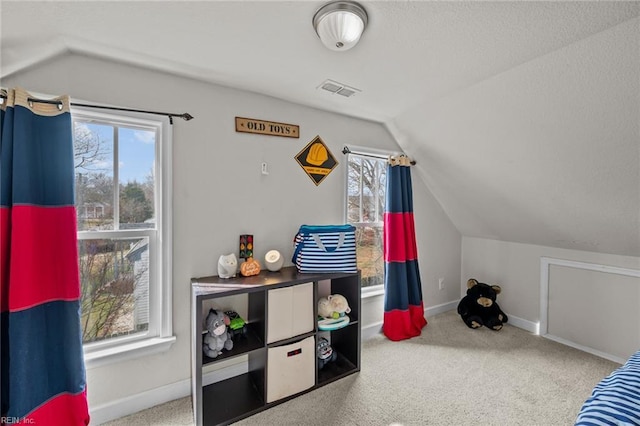 carpeted bedroom featuring vaulted ceiling, visible vents, baseboards, and a textured ceiling