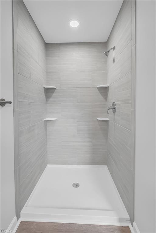 bathroom with a tile shower