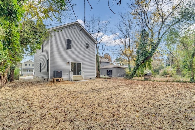 rear view of property with central AC unit and entry steps