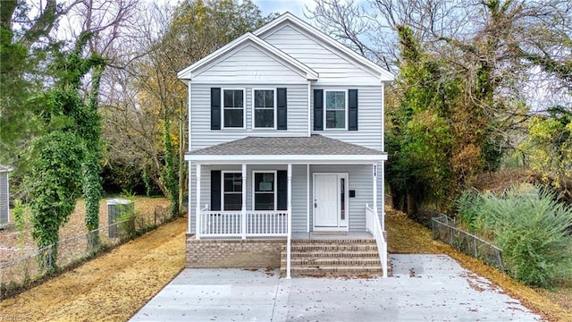 traditional-style home with fence and covered porch