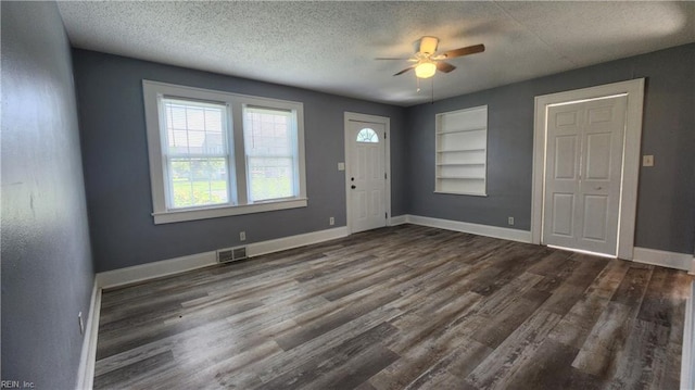 entryway with visible vents, ceiling fan, baseboards, wood finished floors, and a textured ceiling