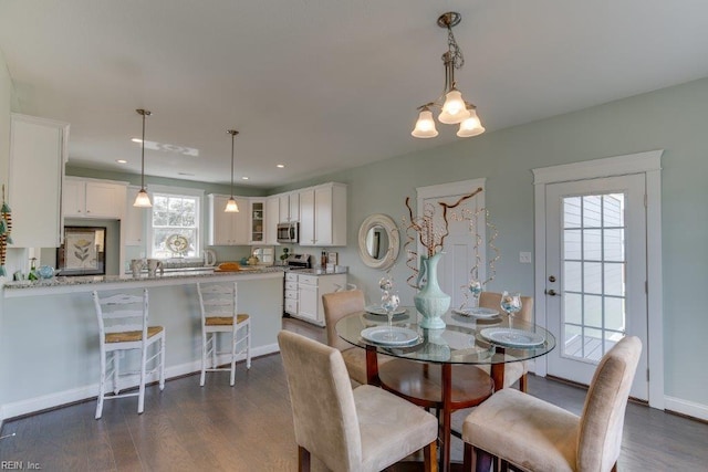 dining space with recessed lighting, baseboards, and dark wood-style floors