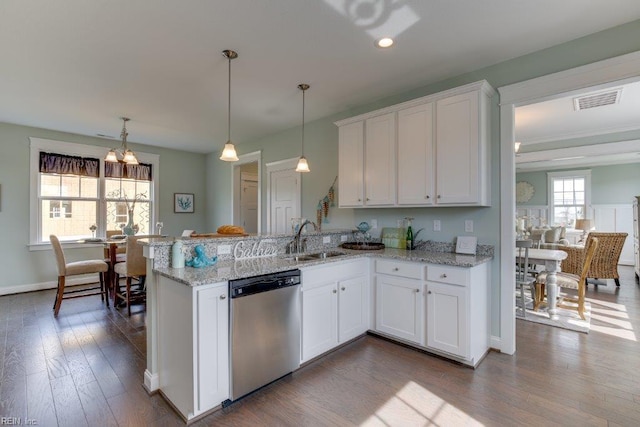 kitchen featuring visible vents, dishwasher, a peninsula, white cabinetry, and a sink