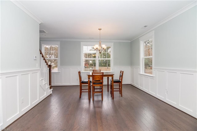 dining space with a notable chandelier, crown molding, stairs, and dark wood-style flooring