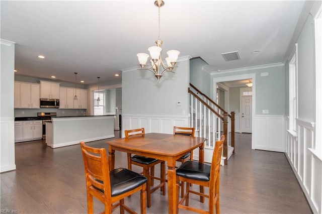 dining space featuring stairs, a decorative wall, dark wood-style floors, and visible vents