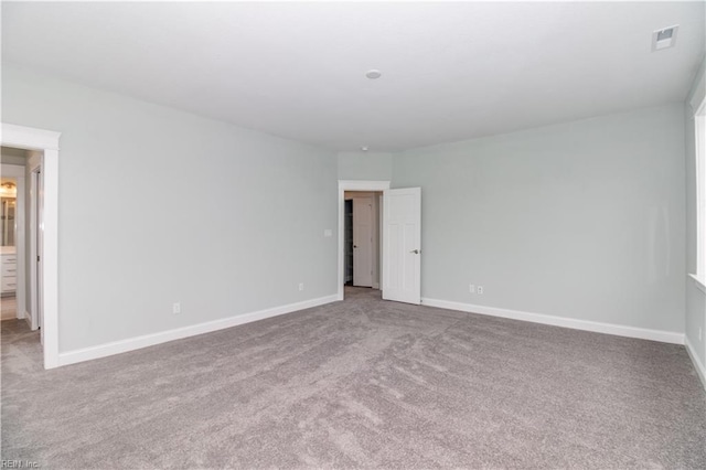 unfurnished bedroom featuring carpet flooring, visible vents, and baseboards