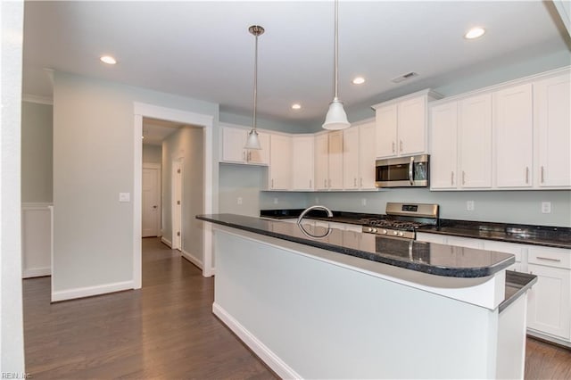 kitchen featuring visible vents, recessed lighting, dark wood-type flooring, appliances with stainless steel finishes, and white cabinetry