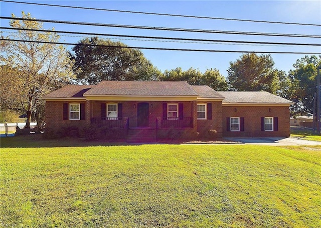 single story home featuring brick siding and a front lawn