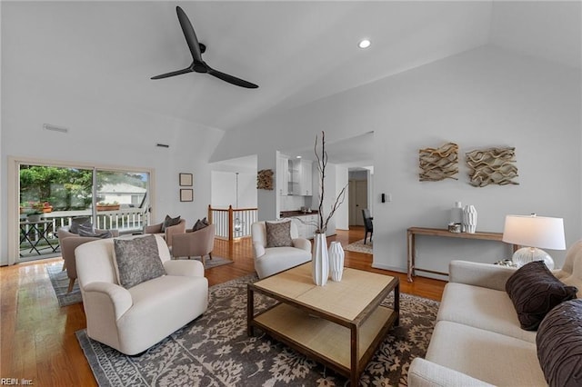 living area with visible vents, vaulted ceiling, recessed lighting, wood finished floors, and a ceiling fan