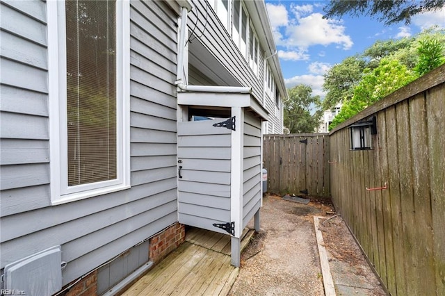 view of side of property featuring crawl space and a fenced backyard