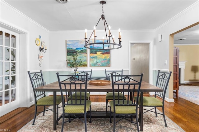 dining area featuring ornamental molding and wood finished floors