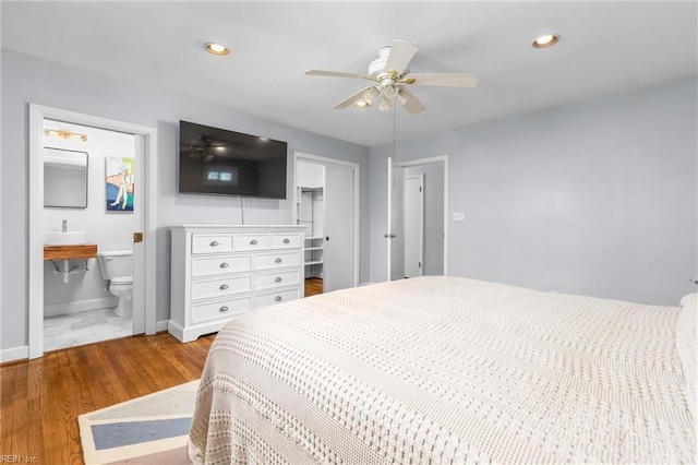 bedroom featuring recessed lighting, wood finished floors, a closet, and baseboards