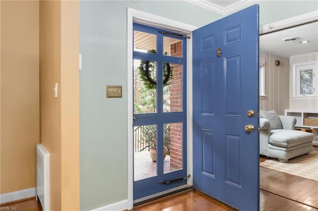 entryway featuring visible vents, baseboards, and wood finished floors